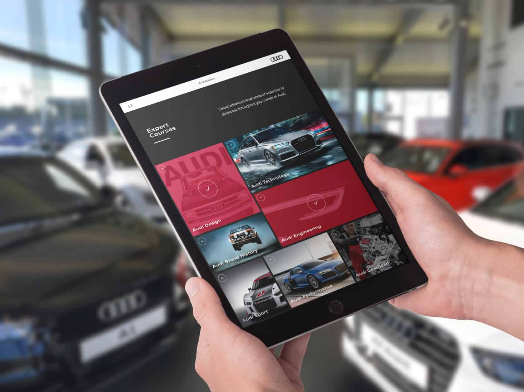 A tablet showing Audi dealer experience courses