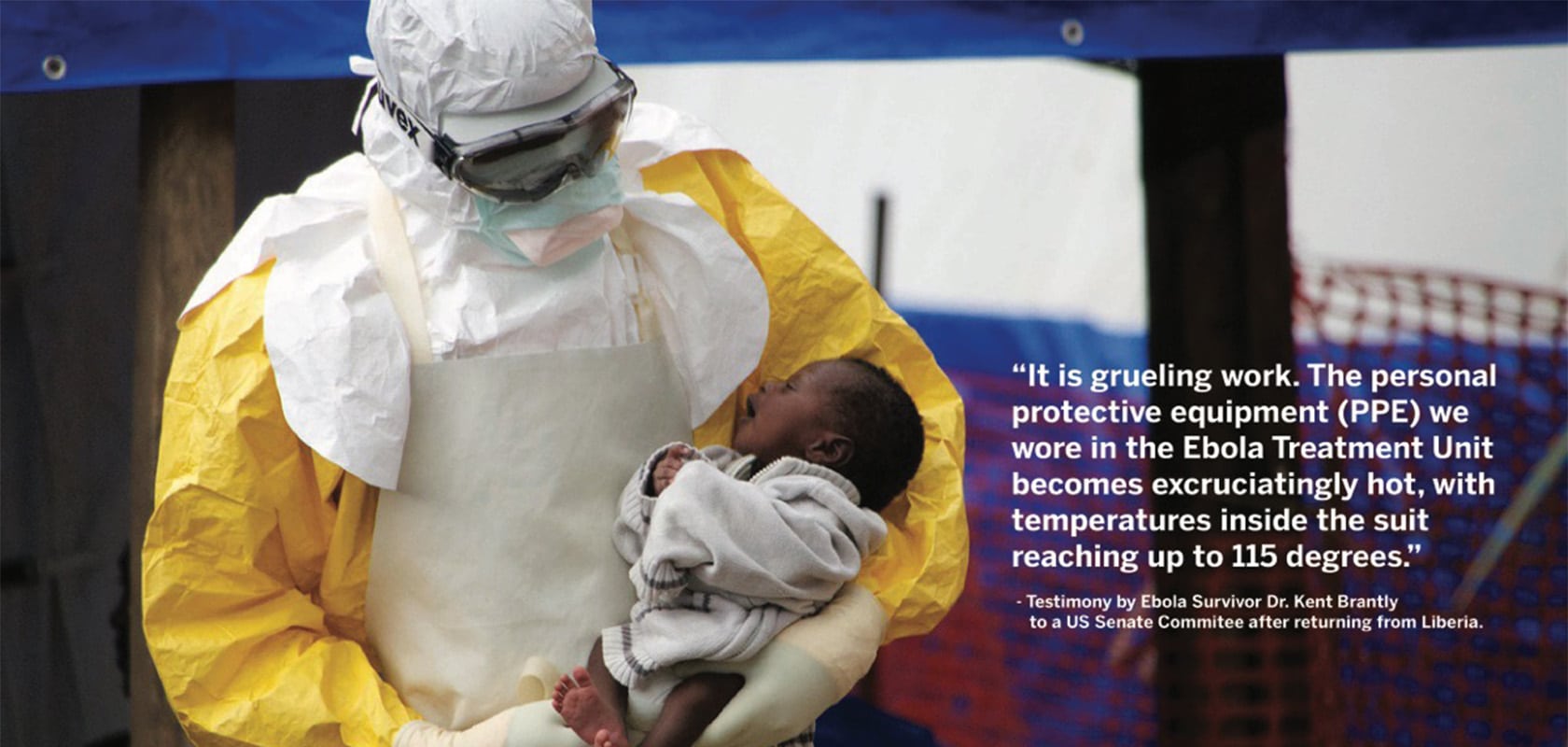 An Ebola aid worker holding a young child